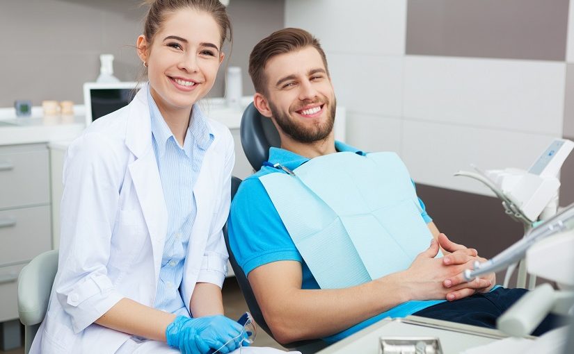 My dentist is the best! Portrait of a female dentist and young man in a dentist office.